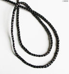 Black and silver string trim with measuring tape for size reference