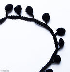 Roll of mini black pom pom fringe ready for use in craft projects.