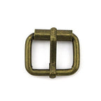 Close-up of an antique gold metal buckle showing detail.