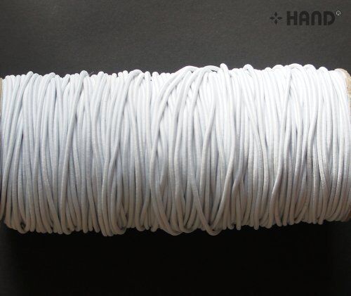 Large roll of 2mm white polyester woven elastic on a table.