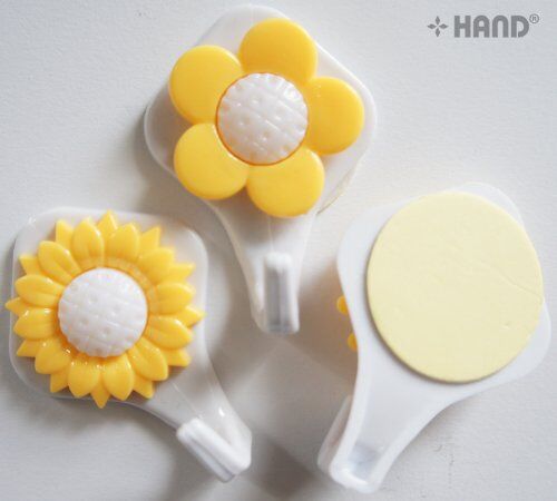 Close-up of a sunflower hook showing its adhesive backing