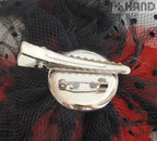Different angles of the dotted feather flower brooches