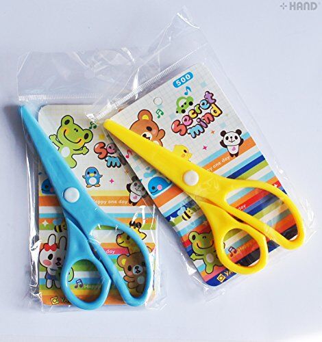 Kids safe scissors displayed on a crafting table with paper.