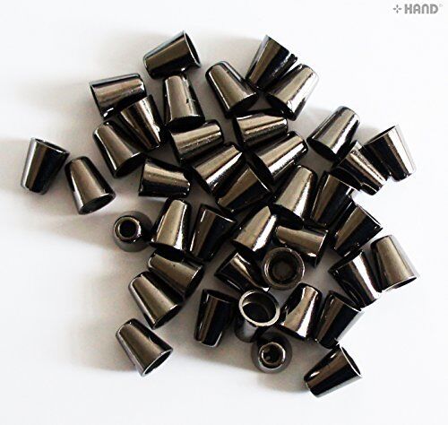 Various dark copper tone cord fastener ends displayed on a surface.