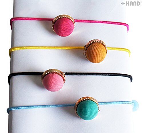 All four pairs of pastel ball hair bands on a flat surface.