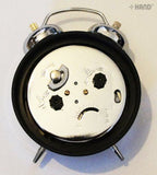 Alarm clock with bells ringing, showcasing its functionality