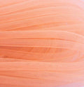 Pale salmon pink 8mm tubular crin trim displayed in a roll.