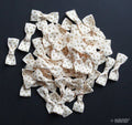 Pack of decorative cream ribbon bows with brown dots.