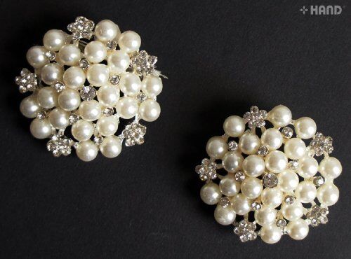 Two vintage brooches featuring elegant pearls and stones.