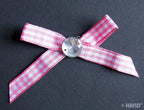 Individual pink and white bow showcasing stone trims