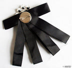 Close-up of the stone and ribbon design on the brooch
