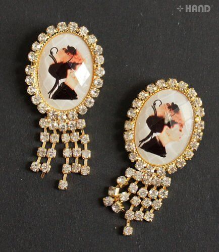 Two elegant small brooches displayed on a white background.