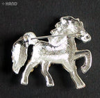 Close-up of a clear crystal horse brooch showcasing its intricate design.