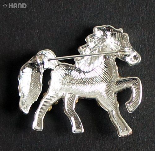 Close-up of a clear crystal horse brooch showcasing its intricate design.