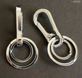 Two solid all metal double key rings displayed together.