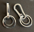 Key rings and buckle set on a neutral background.