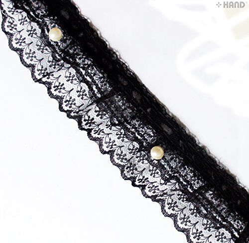 Black decorative lace ruffle trim with pearls on a white background.
