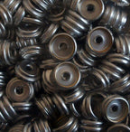 Silver press stud buttons used in a sewing project on fabric.