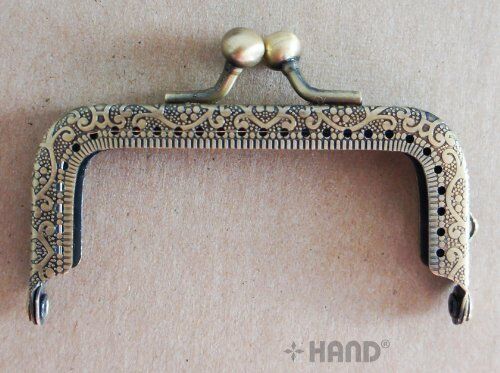 Antique bronze coin purse frame with engraved flowers design.