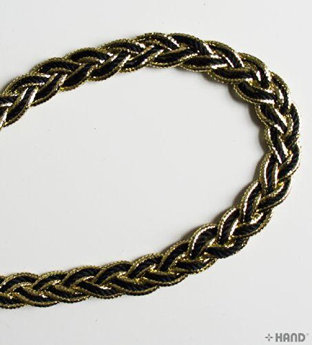 Display of black and gold plait trim on a crafting surface.