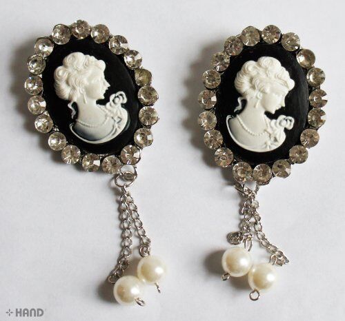 Elegant brooch displayed on a soft fabric background.