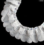 Detail view of sequins on white decorative lace trim