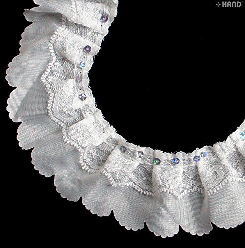 Close-up of white decorative two layer nylon lace trim with sequins