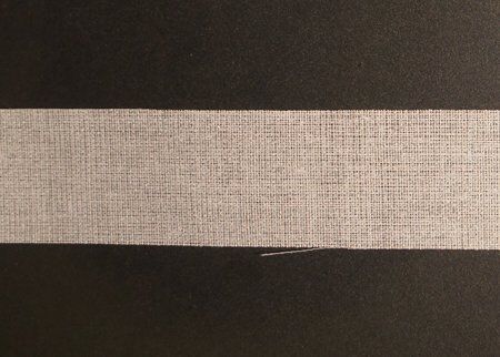 Application of the iron-on waist band fuse on tailored trousers.
