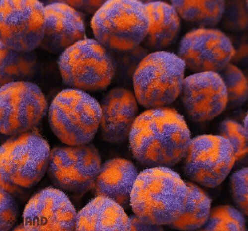 Close-up of colourful POM POMS in purple and orange hues.