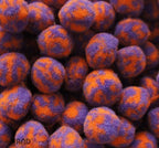 Close-up of colourful POM POMS in purple and orange hues.