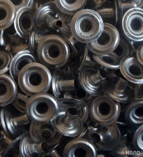 Pack of silver press stud buttons with a measuring tape for size reference.