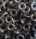 Pack of silver press stud buttons with a measuring tape for size reference.
