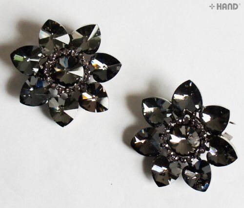 Two vintage dark stone flower brooches displayed on a white background.