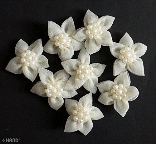 Arrangement of white flowers with pearls for wedding crafts.