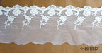 Vintage cream embroidered tulle lace edging on a roll.
