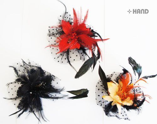 Three dotted feather flower brooches displayed together