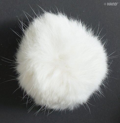 Close-up of a white rabbit bobble ball trim showing its fluffy texture.