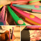 Scissors cutting decorative paper with a serrated edge
