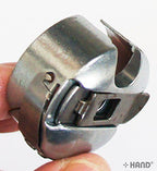 Towa bobbin case displayed on a sewing machine.