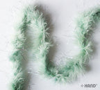 Close-up view of the silver trim on the mint green feather garland.