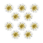 Close-up of white enamel and brass flower sew-on trim.