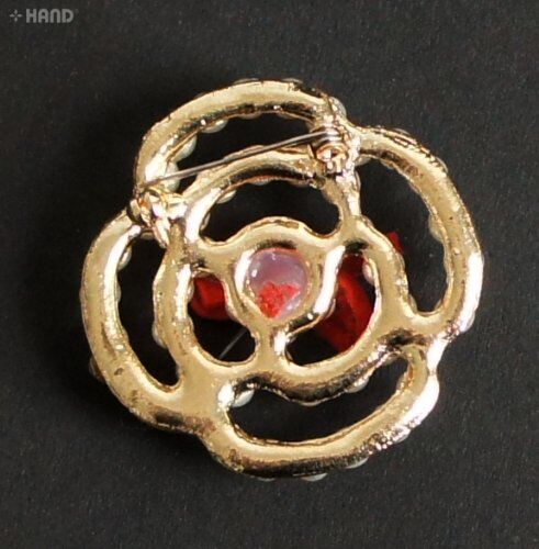 Close-up of a pearl brooch showcasing its intricate design.