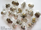 Close-up of a pack of 4 jeans buttons, ideal for sewing projects.