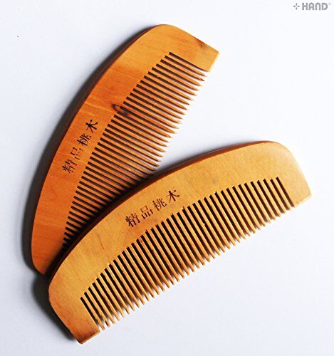 Natural peach wood combs in a travel pouch for easy storage.