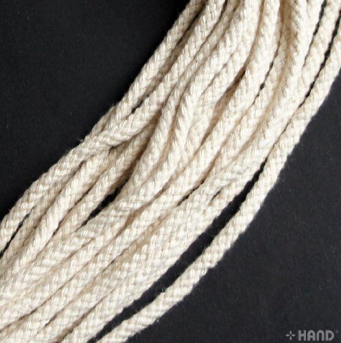 Cream rope cord displayed on a wooden surface