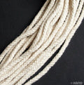 Cream rope cord displayed on a wooden surface