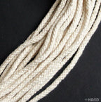 Cream rope cord displayed on a wooden surface