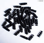 Display of small plastic toggle spring stop cord locks in packaging.