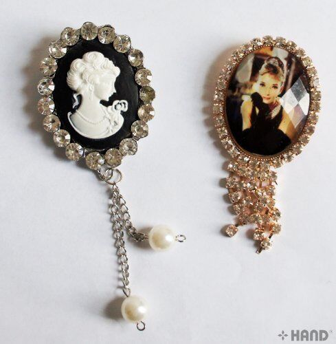 Two assorted vintage brooches displayed on a white background.