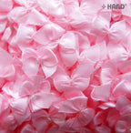 Display of small decorative ribbon bows with pearl detailing